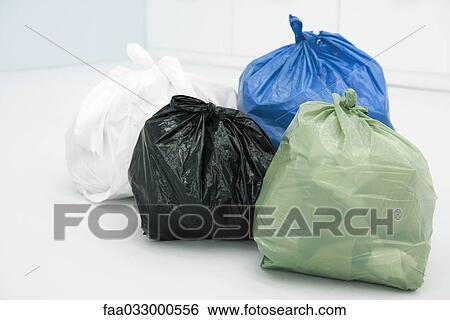 Stock Photograph - Assortment of garbage bags, all full. Fotosearch