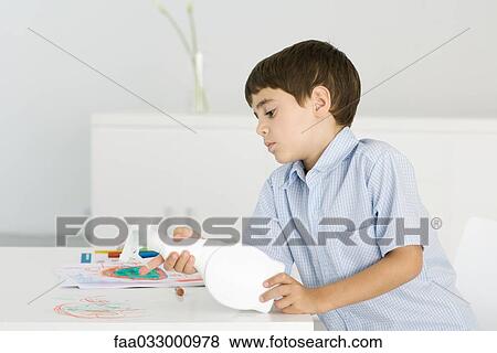 Boy cleaning crayon scribbles off of table, holding spray bottle View Large Photo Image Stock Photo - Boy cleaning crayon scribbles off of table, holding spray bottle. Fotosearch