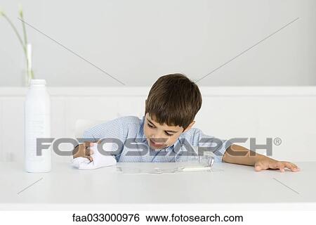Boy wiping up spilled milk with towel View Large Photo Image Stock Photograph - Boy wiping up spilled milk with towel. Fotosearch