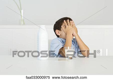 Boy with spilled milk, covering face with hands View Large Photo Image Stock Photography - Boy with spilled milk, covering face with hands. Fotosearch