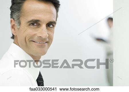 Businessman smiling at camera View Large Photo Image Stock Image - Businessman smiling at camera. Fotosearch