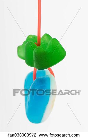 Candy hanging from string, close-up View Large Photo Image Stock Image - Candy hanging from string, close-up. Fotosearch