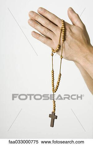 Clasped hands holding rosary with crucifix, cropped view View Large Photo Image Stock Photography - Clasped hands holding rosary with crucifix, cropped view. Fotosearch