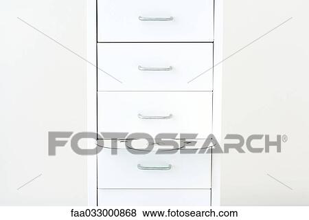Stock Photo - DVDs emerging from filing cabinet. Fotosearch