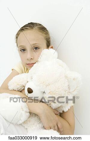 girl holding teddy bear