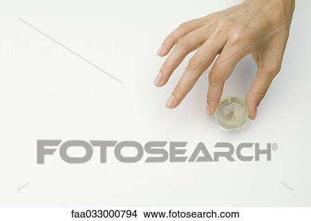 Hand holding tiny globe, cropped view View Large Photo Image Picture - Hand holding tiny globe, cropped view. Fotosearch