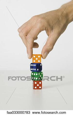 Hand stacking colorful dice, cropped view View Large Photo Image Stock Image - Hand stacking colorful dice, cropped view. Fotosearch
