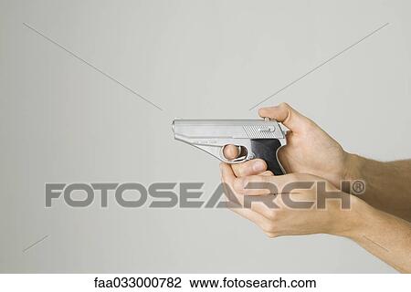 Hands holding and aiming toy gun, side view View Large Photo Image Stock Image - Hands holding and aiming toy gun, side view. Fotosearch