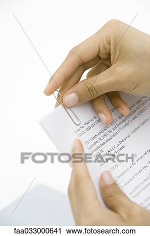 Hands putting paper clip on contract View Large Photo Image Stock Image - Hands putting paper clip on contract. Fotosearch