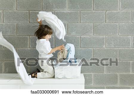 Little boy playing with laundry, smiling, side view View Large Photo Image Stock Image - Little boy playing with laundry, smiling, side view. Fotosearch