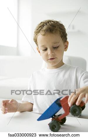 Little boy playing with toy dump truck View Large Photo Image Stock Image - Little boy playing with toy dump truck. Fotosearch
