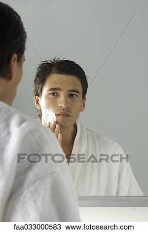 Man applying shaving cream, looking at self in mirror View Large Photo Image Stock Image - Man applying shaving cream, looking at self in mirror. Fotosearch