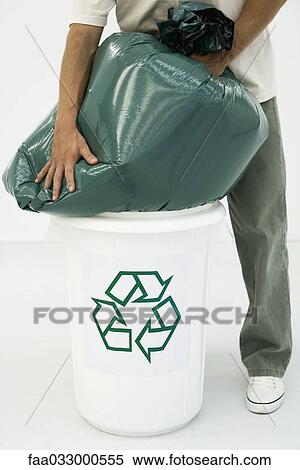 Man forcing large garbage bag into recycling bin, cropped view View Large Photo Image Stock Photography - Man forcing large garbage bag into recycling bin, cropped view. Fotosearch