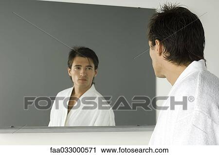 Man in bathrobe looking at self in mirror View Large Photo Image Stock Image - Man in bathrobe looking at self in mirror. Fotosearch