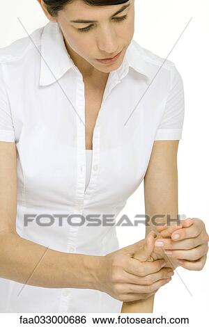 Stock Photograph - Massage therapist giving hand massage, cropped view. Fotosearch