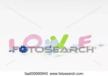 Paper flowers and letters spelling the word "love" View Large Photo Image Stock Image - Paper flowers and letters spelling the word "love". Fotosearch