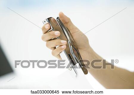 Person stapling document, cropped view of hand View Large Photo Image Stock Photography - Person stapling document, cropped view of hand. Fotosearch