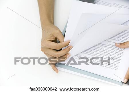 Person thumbing through pages of document, cropped view of hands View Large Photo Image Stock Image - Person thumbing through pages of document, cropped view of hands. Fotosearch