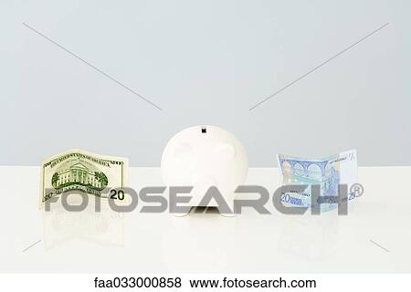 Piggy bank with folded twenty dollar bill to one side and a twenty euro bill on the other side View Large Photo Image Stock Photo - Piggy bank with folded twenty dollar bill to one side and a twenty euro bill on the other side. Fotosearch