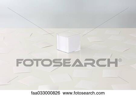 Scattered sheets of paper around a stack of paper in plastic container View Large Photo Image Stock Photograph - Scattered sheets of paper around a stack of paper in plastic container. Fotosearch