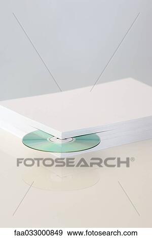 Stack of paper with CD emerging from the corner View Large Photo Image Stock Photo - Stack of paper with CD emerging from the corner. Fotosearch