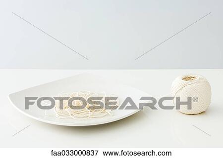 Stock Photo - String on plate, imitating spaghetti. Fotosearch