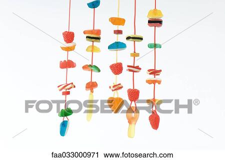 Stock Image - Strings of colorful candy. Fotosearch