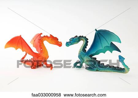 Stock Photo - Toy dragons face to face, side view. Fotosearch