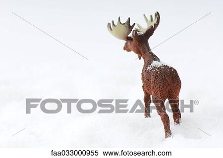 Stock Photography - Toy moose in snow, rear view. Fotosearch