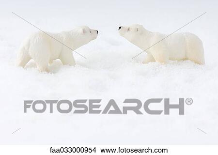 Picture - Toy polar bears in snow, face to face, side view. Fotosearch