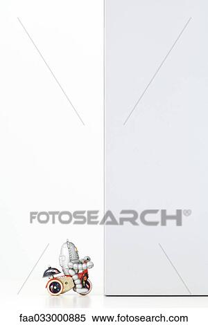 Toy robot riding bicycle, wall blocking the way View Large Photo Image Stock Photography - Toy robot riding bicycle, wall blocking the way. Fotosearch