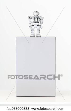 Toy robot standing on top of pedestal with batteries exposed, rear view View Large Photo Image Stock Photo - Toy robot standing on top of pedestal with batteries exposed, rear view. Fotosearch