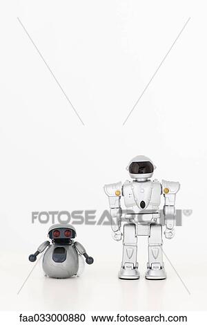Toy robots looking at camera, side by side View Large Photo Image Stock Image - Toy robots looking at camera, side by side. Fotosearch