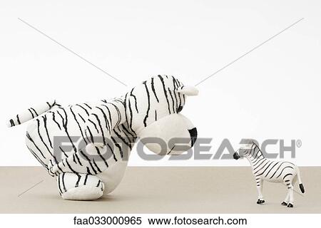 Toy tiger facing toy zebra, side view View Large Photo Image Stock Photography - Toy tiger facing toy zebra, side view. Fotosearch