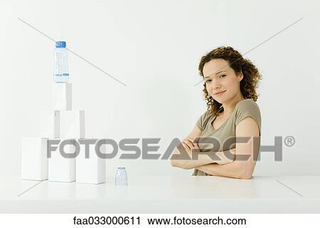 Woman beside stacked milk cartons and baby bottle, arms folded, smiling at camera View Large Photo Image Stock Image - Woman beside stacked milk cartons and baby bottle, arms folded, smiling at camera. Fotosearch