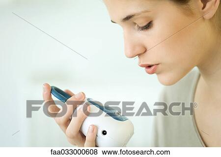 Woman holding baby monitor, close-up View Large Photo Image Stock Photo - Woman holding baby monitor, close-up. Fotosearch