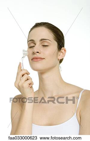 Woman massaging her face, eyes closed View Large Photo Image Stock Image - Woman massaging her face, eyes closed. Fotosearch