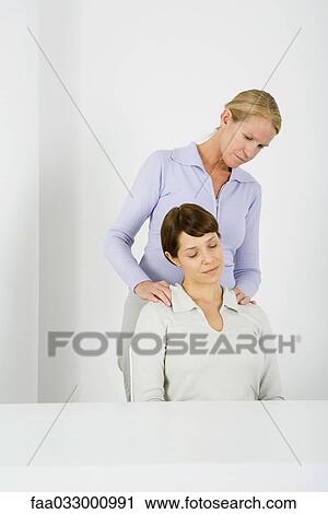 Woman massaging her partner's shoulders, partner's eyes closed View Large Photo Image Stock Image - Woman massaging her partner's shoulders, partner's eyes closed. Fotosearch