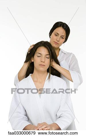 Stock Photo - Woman receiving head massage, eyes closed. Fotosearch