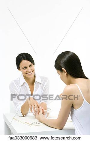 Woman receiving manicure, smiling View Large Photo Image Stock Image - Woman receiving manicure, smiling. Fotosearch