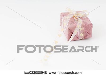 Wrapped gift with heart ribbon View Large Photo Image Stock Photo - Wrapped gift with heart ribbon. Fotosearch