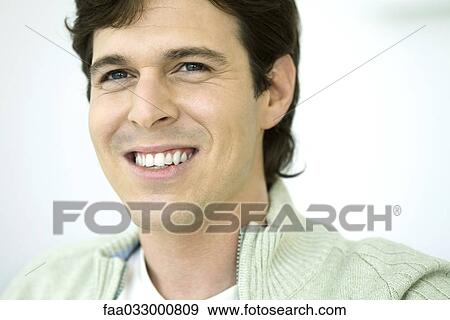 Young man smiling and looking away, close-up, portrait View Large Photo Image Stock Photo - Young man smiling and looking away, close-up, portrait. Fotosearch