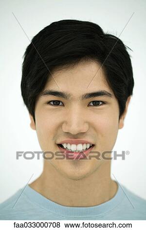 Young man smiling at camera, portrait View Large Photo Image Stock Photo - Young man smiling at camera, portrait. Fotosearch
