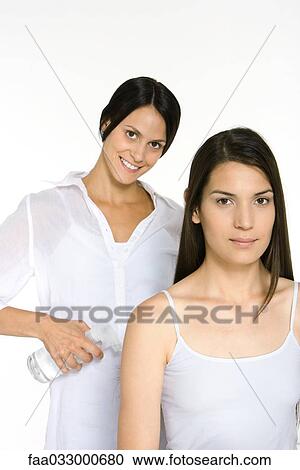 Young woman and hair stylist smiling at camera, stylist holding spray bottle View Large Photo Image Stock Image - Young woman and hair stylist smiling at camera, stylist holding spray bottle. Fotosearch