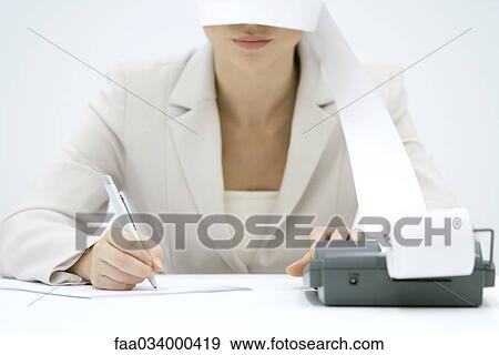 Accountant using adding machine, printout wrapped around her face like blindfold, cropped view View Large Photo Image Stock Photo - Accountant using adding machine, printout wrapped around her face like blindfold, cropped view. Fotosearch