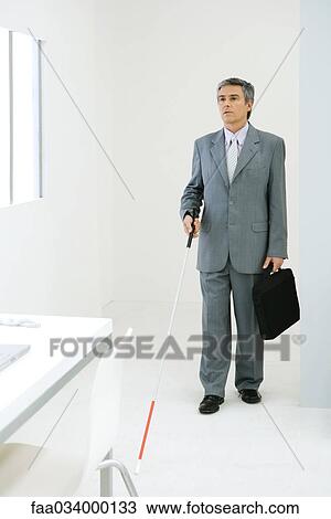 Blind businessman entering office, using white cane View Large Photo Image Stock Image - Blind businessman entering office, using white cane. Fotosearch