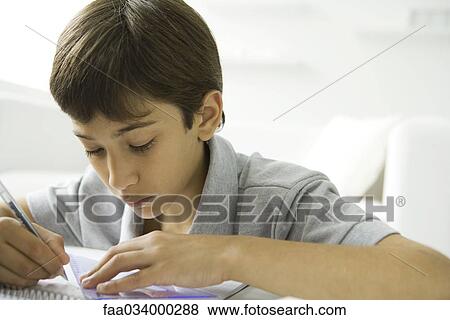 Boy doing homework, close-up View Large Photo Image Stock Photo - Boy doing homework, close-up. Fotosearch