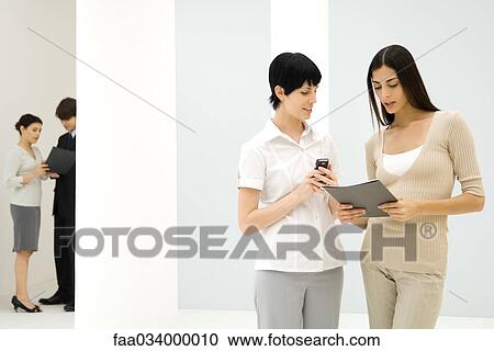 Business associates meeting in hallway View Large Photo Image Stock Image - Business associates meeting in hallway. Fotosearch