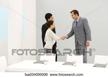 Stock Photograph - Business associates shaking hands. Fotosearch
