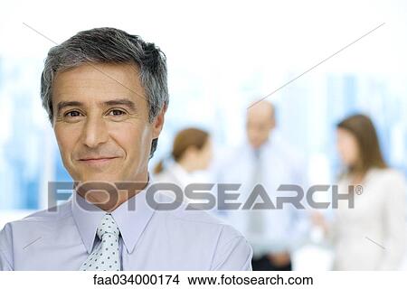 Picture - Business executive smiling at camera, portrait. Fotosearch